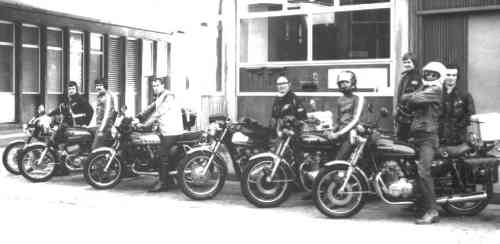 A group from the late 70s lined up, all on Japanese motorcycles.
